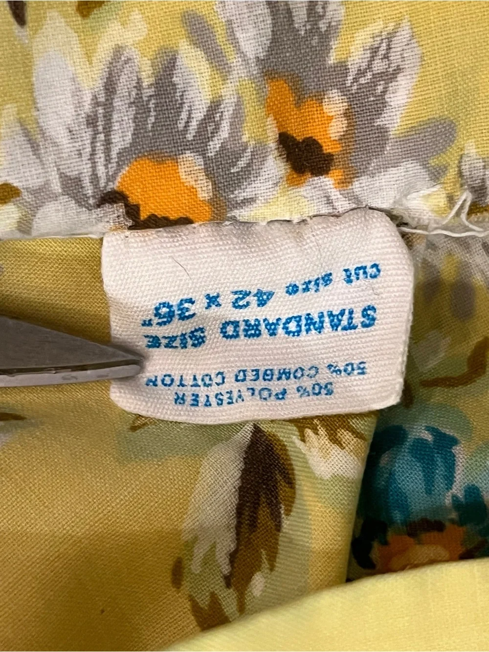 Vintage Montgomery Ward cream floral pillow case with yellow edge accent.